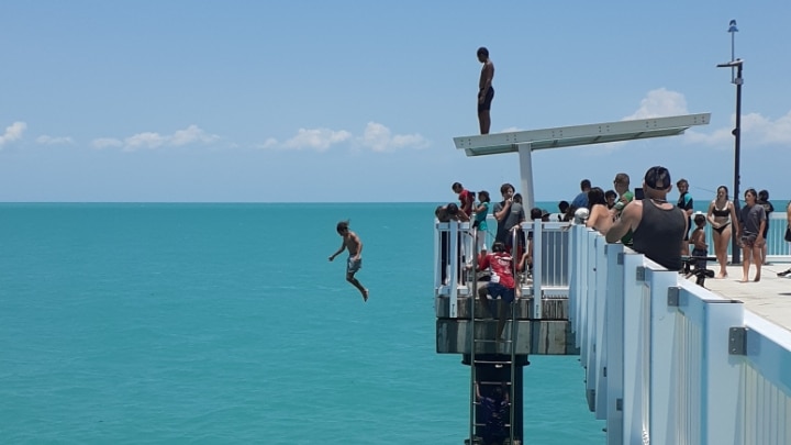A person jumps of a jetty.