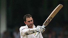Justin Langer salutes the crowd after notching his ton