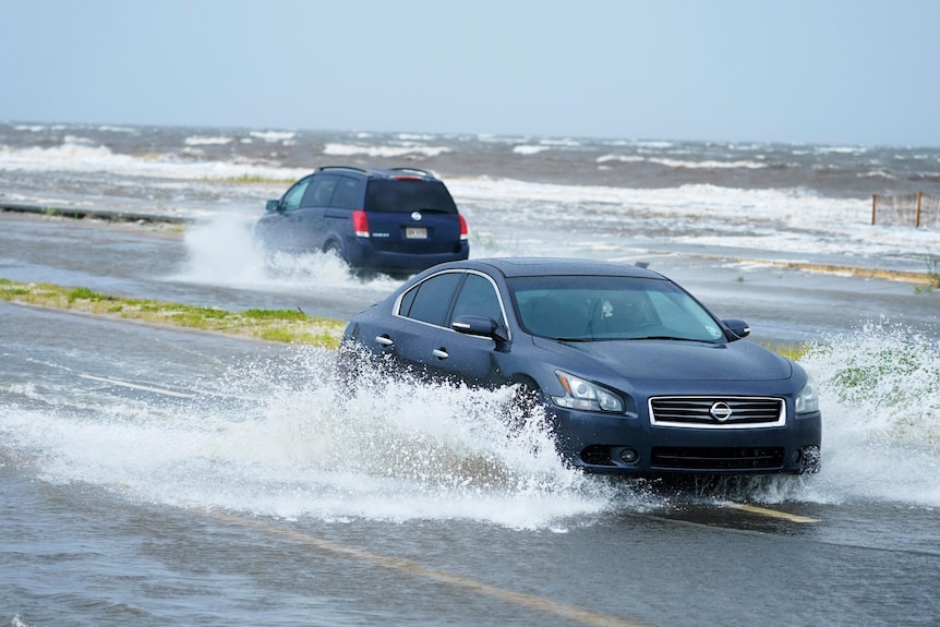 Cars drive through flood waters caused by Hurricane Ida 