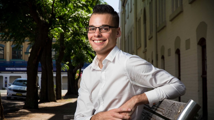 Alex Cowan sits on a bench.