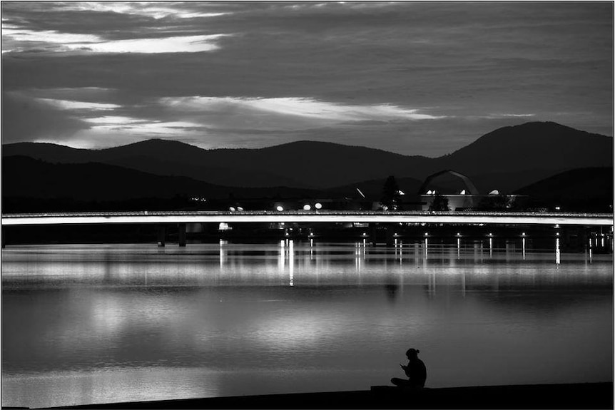 An empty Lake Burley Griffin during coronavirus restrictions, the National Museum in the background