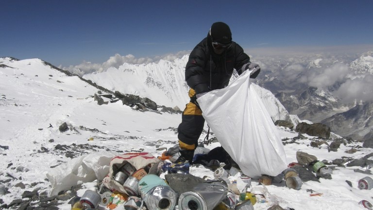 Nepalese Sherpa collects rubbish on Mount Everest