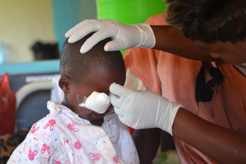 Nurse removes Faith's eye patches