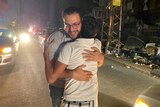 Two men hug each other on the streets of Gaza.