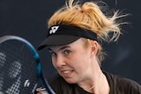 A Czech female professional tennis player hits a forehand.