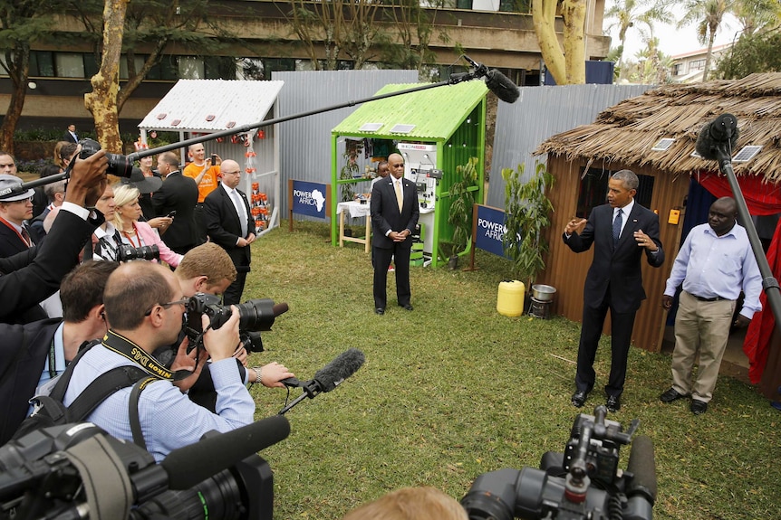 US president Barack Obama addresses the media while talking with solar power business people