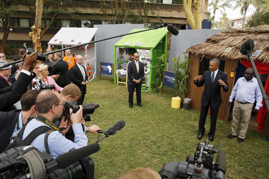 US president Barack Obama addresses the media while talking with solar power business people