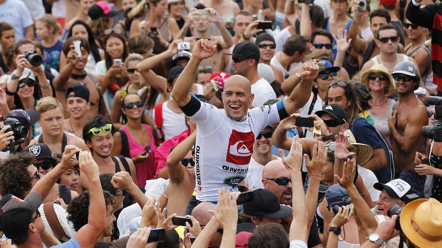 Kelly Slater celebrates winning the Quiksilver Pro