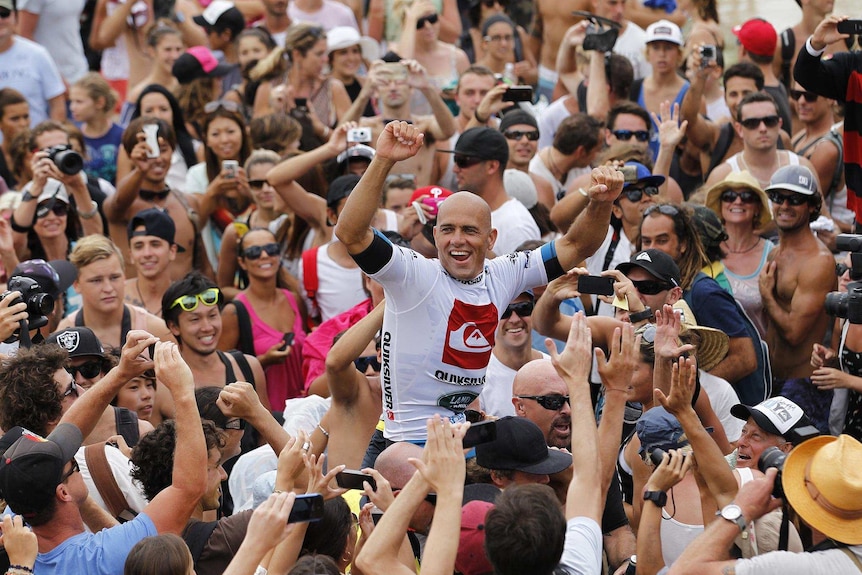 Kelly Slater celebrates winning the Quiksilver Pro