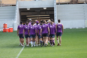 Craig Bellamy leads his Melbourne Storm squad off the field at the Rectangle (David Crosling/AAP)