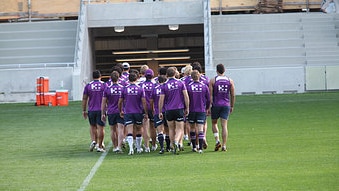 Craig Bellamy leads his Melbourne Storm squad off the field at the Rectangle (David Crosling/AAP)