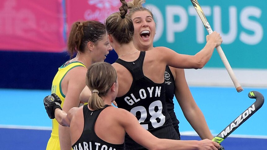 Shiloh Gloyn of New Zealand (second right) celebrates with team mates after scoring against Australia