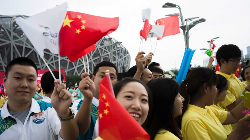 Volunteers in China celebrate Beijing's win to host the 2022 Winter Olympic Games