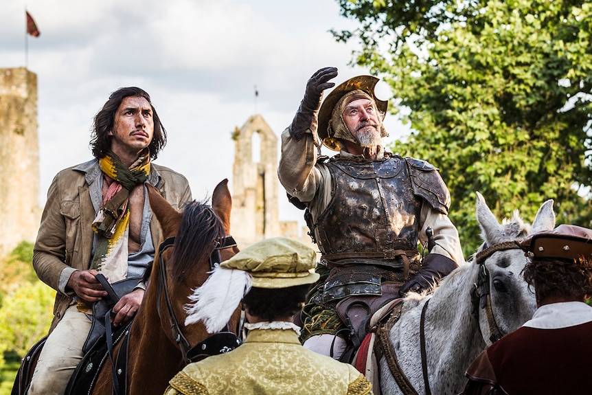 Colour still of Adam Driver and Jonathan Pryce sitting on horses in 2018 film The Man Who Killed Don Quixote.