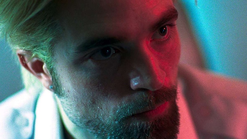 Still colour close-up image of Robert Pattinson's face looking to the right, off camera.