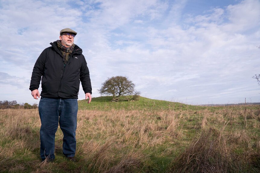 Brian Edwards in front of a Stonehenge burial mound.