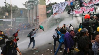Students clash with police armed with water cannons and tear gas