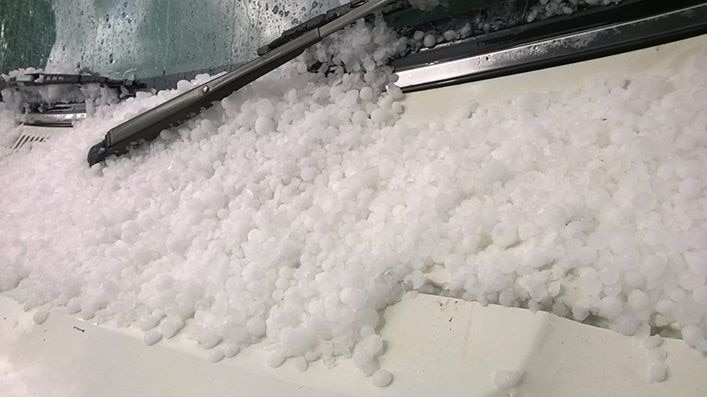 Hail piled on the windscreen of a vehicle