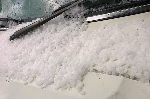 Hail piled on the windscreen of a vehicle