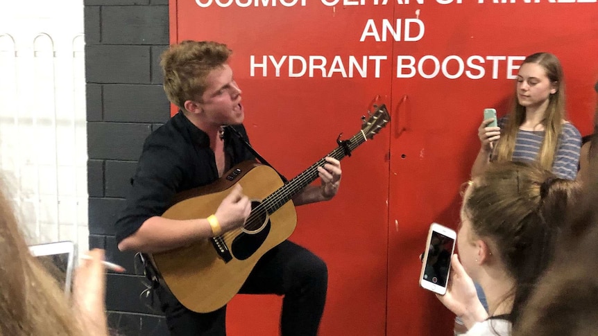 Fergus James performing to Adelaide fans in a car park