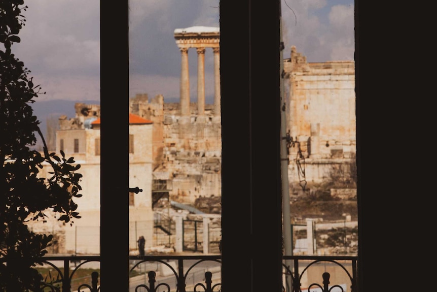 The ruins of Baalbek viewed through a window of the Palmyra Hotel.