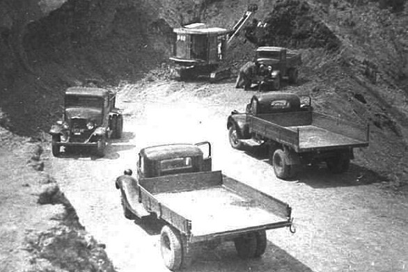 Old vehicles parked at a mining area.