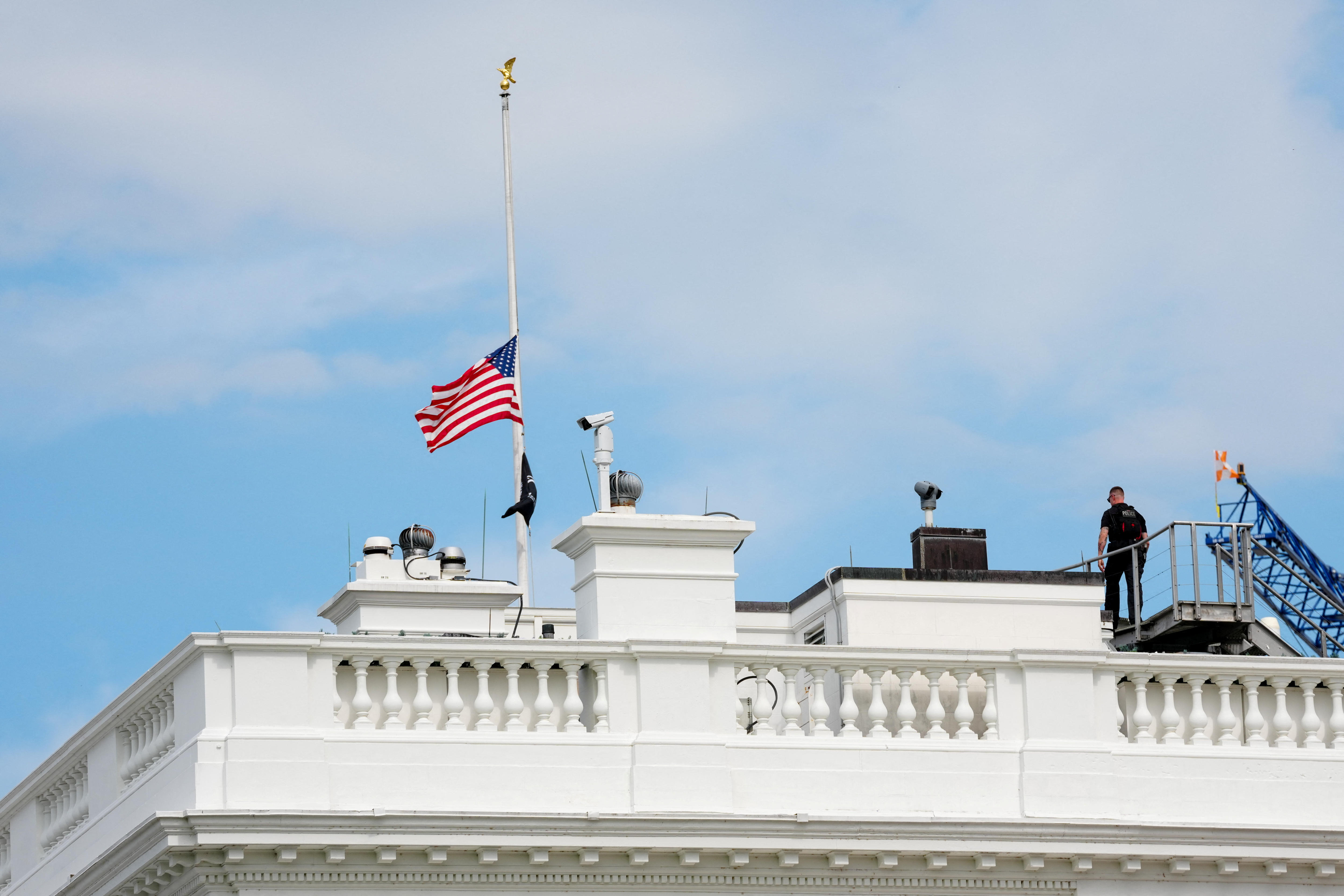 A US flag flies at half-staff atop the White House