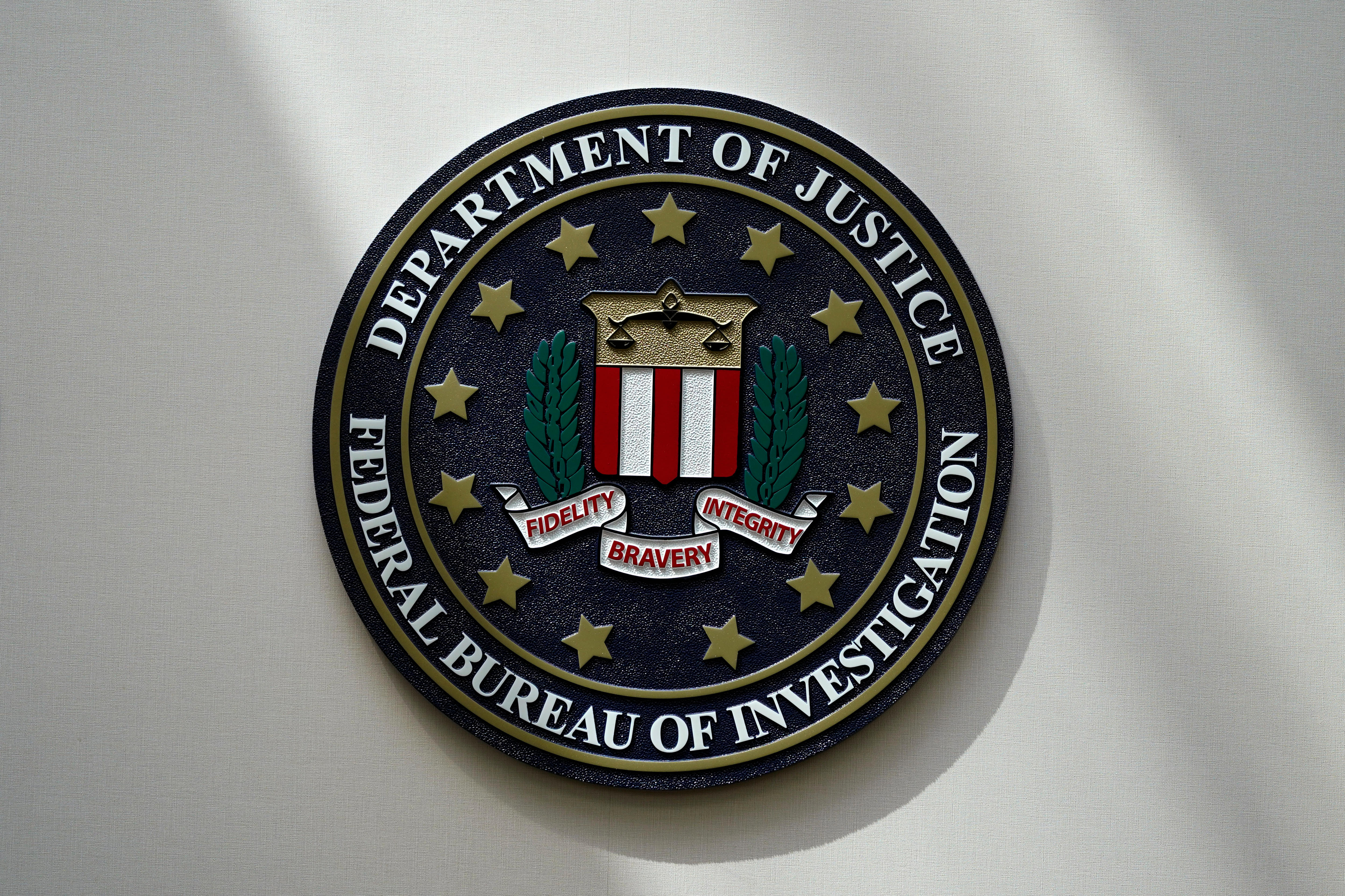 FBI seal on a wall with the words department of justice, federal bureau of investigation 