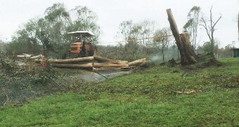 A tractor and a tree that upturned itself and crushed a 12 year old boy after falling in a severe storm in the South Burnett.