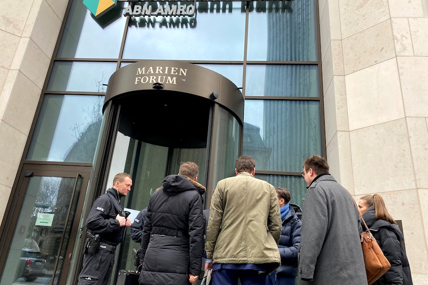 Police stand outside a bank.