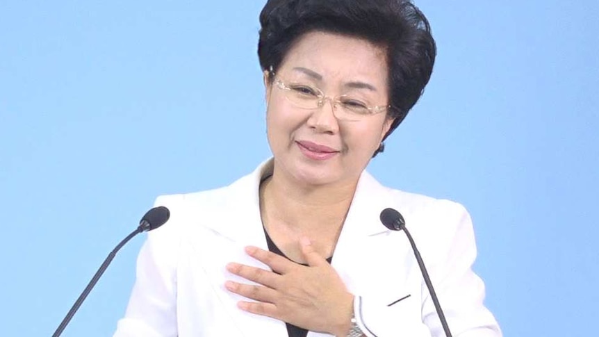 Shin Ok-ju places her hand on her heart, during a sermon at the Grace Road Church.