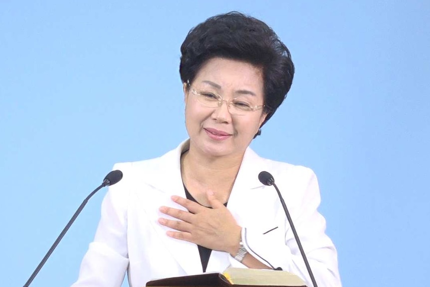 Shin Ok-ju places her hand on her heart, during a sermon at the Grace Road Church.