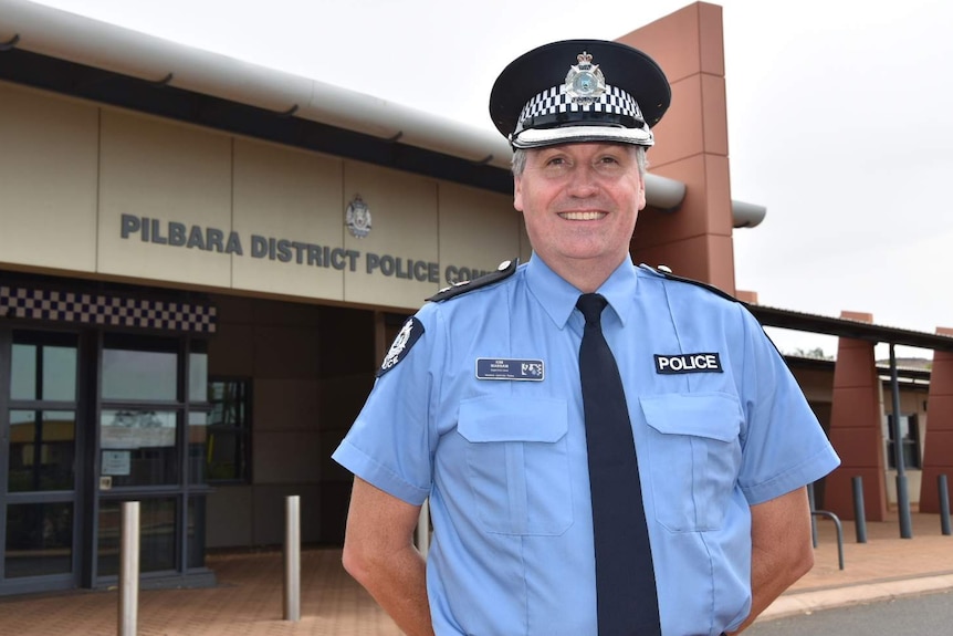 A smiling Superintendent Massam standing outside the Pilbara District Police Complex.