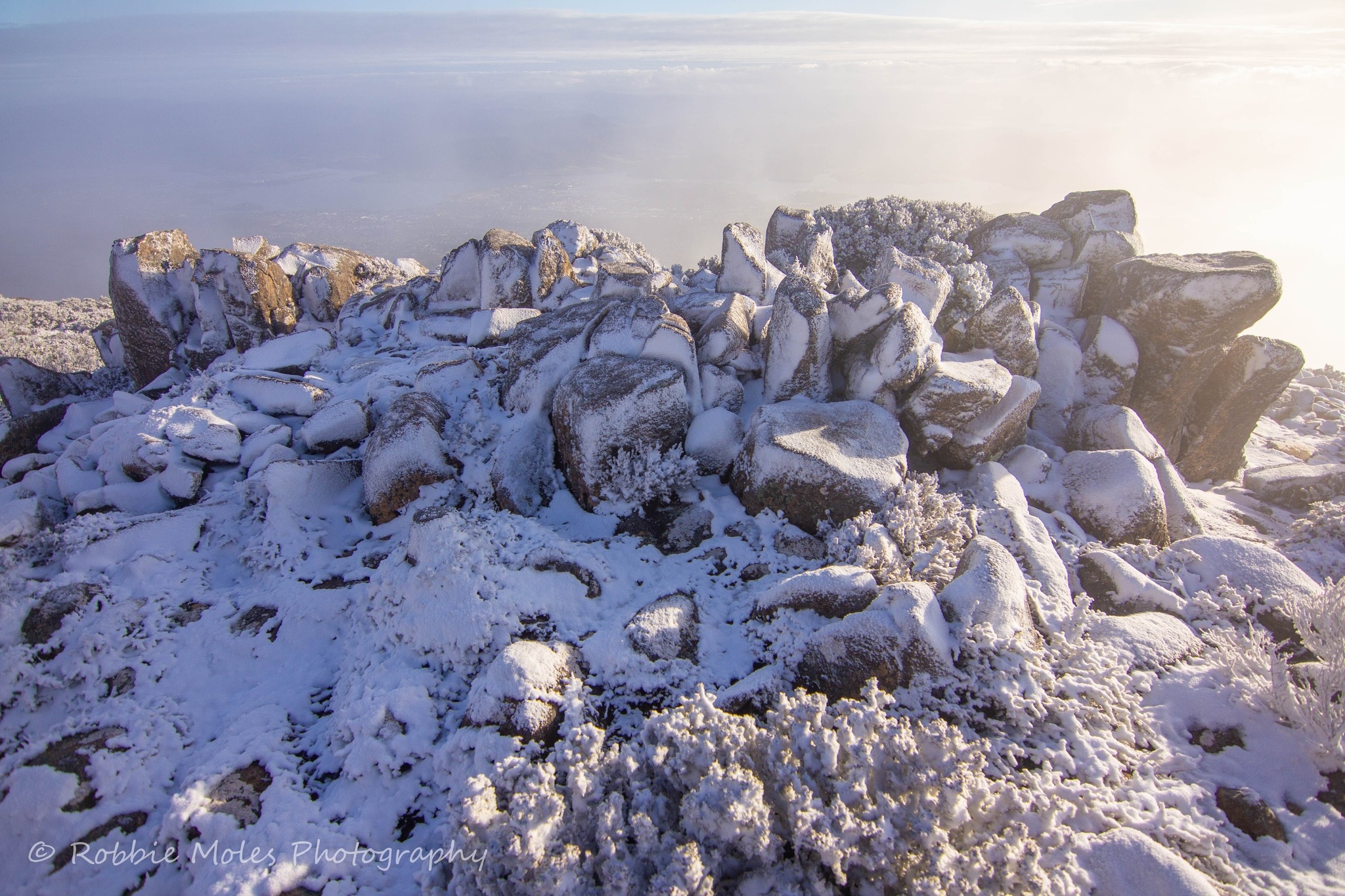 A dusting of snow over jagged rocks atop Mt Wellington in the morning