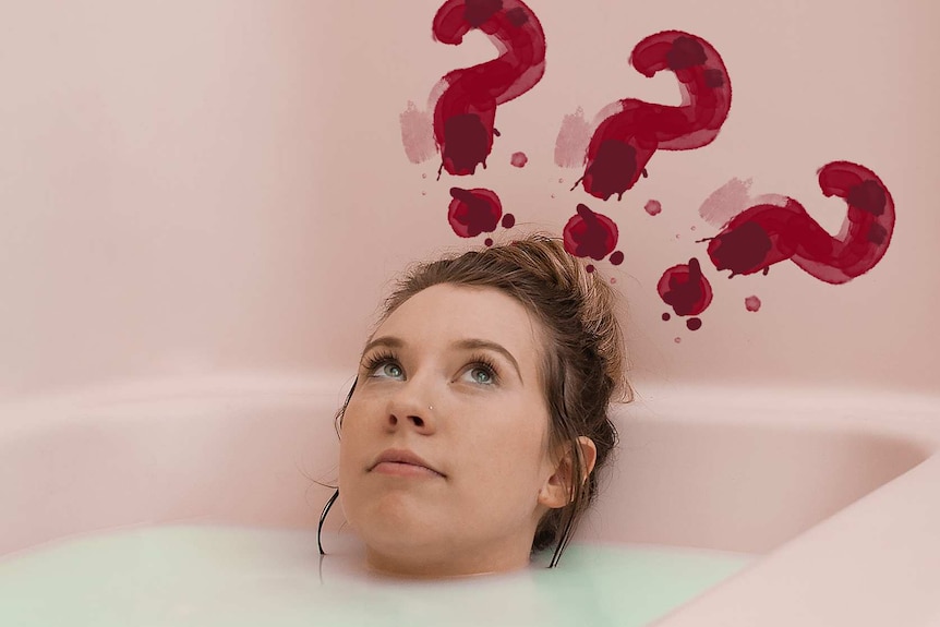 Woman lying in a bath with three red question marks above her head for a story about facts about periods no-one tells you.
