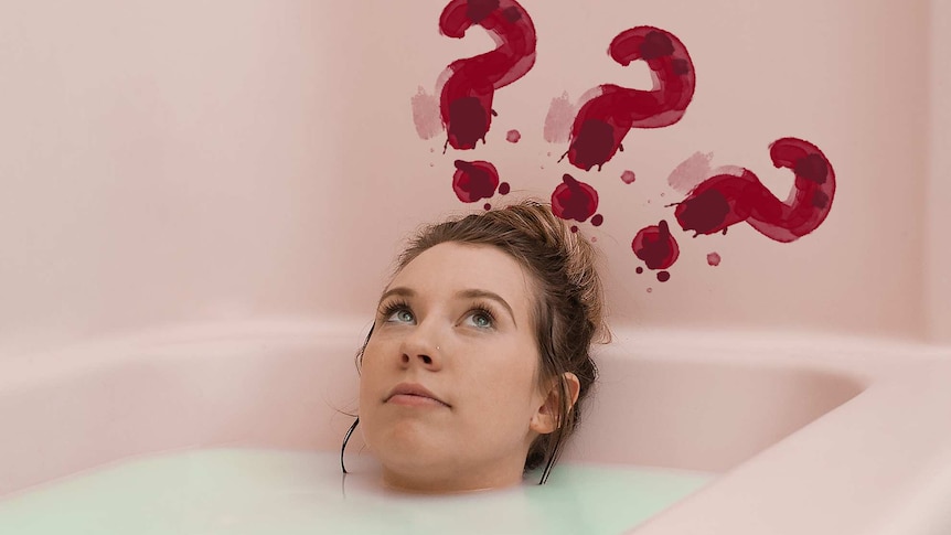 Woman lying in a bath with three red question marks above her head for a story about facts about periods no-one tells you.