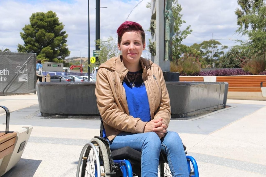 Emily Harman in a wheelchair outdoors.