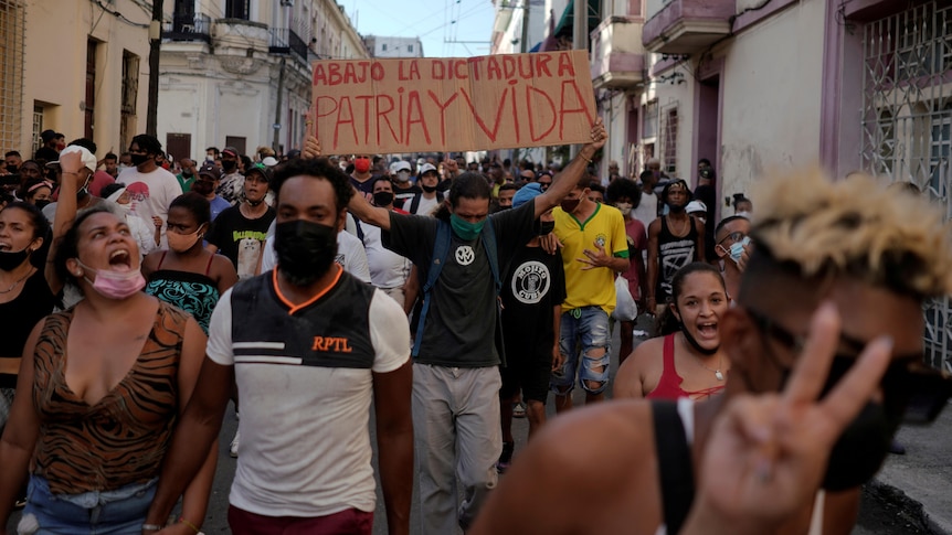 People shout slogans against the government during a protest.