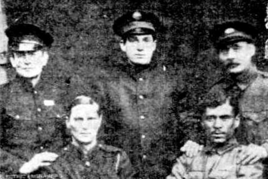 A group of men pose for a photo at a POW camp in Germany in WWI.