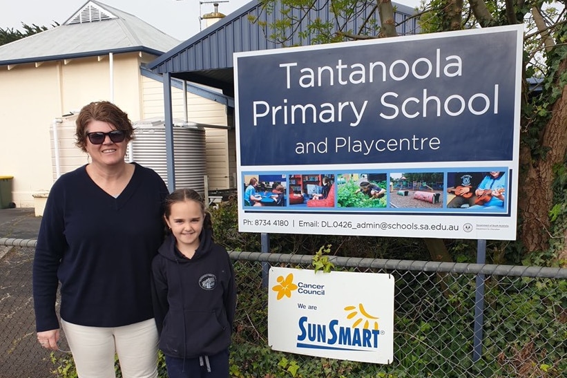 Chair of Tantanoola Primary School's Governing Council Colleen Roberts is standing outside the school with her daughter.