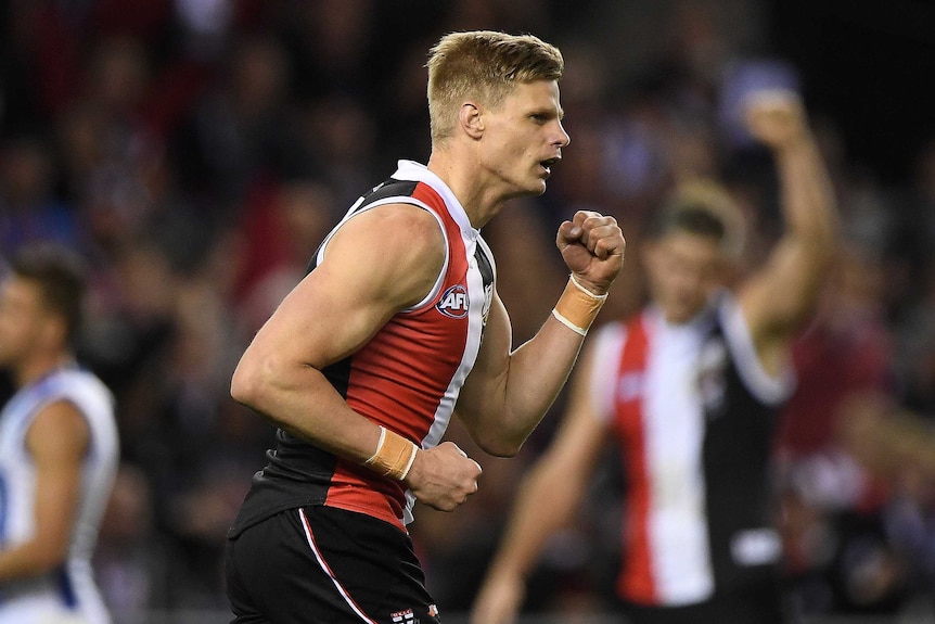 Nick Riewoldt pumps his fist as he runs on the field.