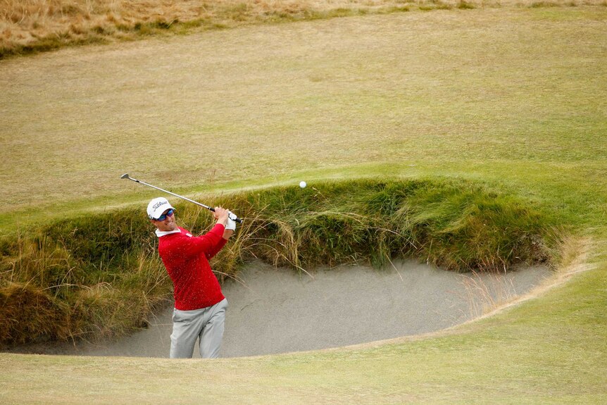 Adam Scott plays from the bunker at the US Open