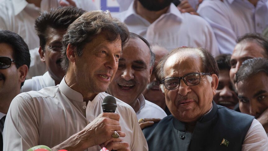 Pakistani opposition politician Imran Khan speaks to a crowd of supporters