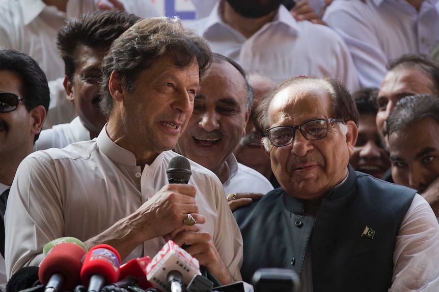 Pakistani opposition politician Imran Khan speaks to a crowd of supporters