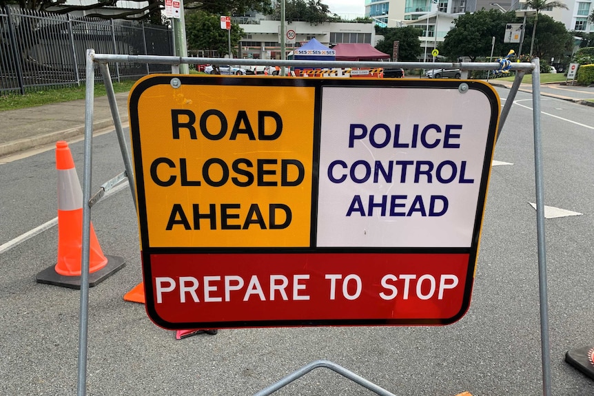 A sign at the Coolangatta border reads 'Road Closed ahead, police control ahead'.
