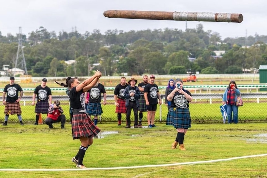 Lily Riley flips a log in the caber toss even at the Australian Highland Games. 