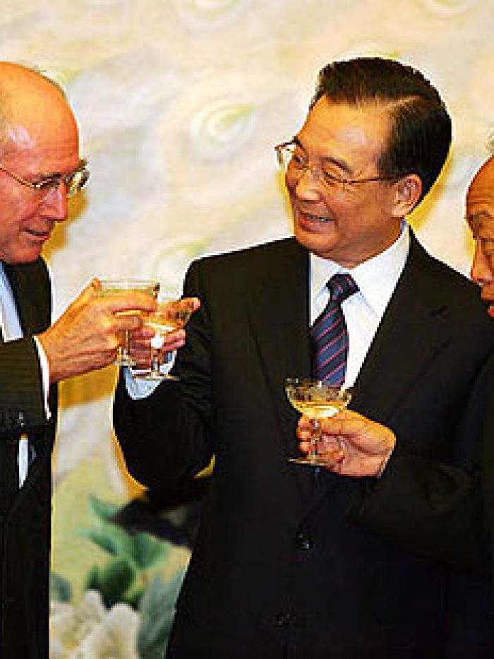 Close-up of three men sharing a toast.