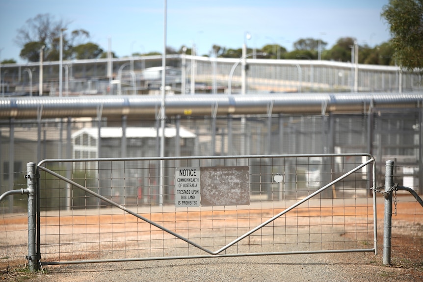 Shot of steel gate with sign saying "Commonwealth of Australia"