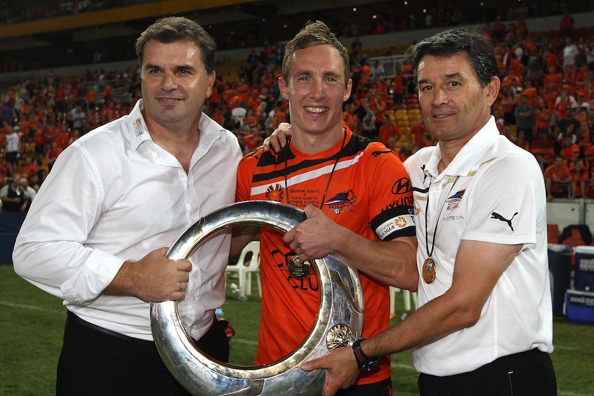 Ange Postecoglou, Matt Smith and Dario Vidosic hold the A-League men's championship trophy