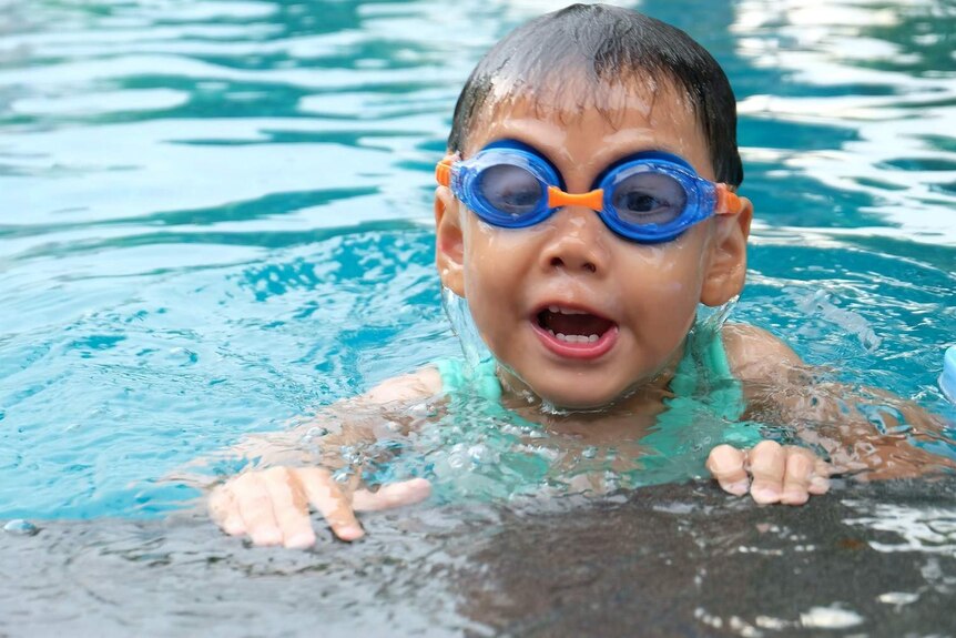 A generic shot of a child swimming in a pool